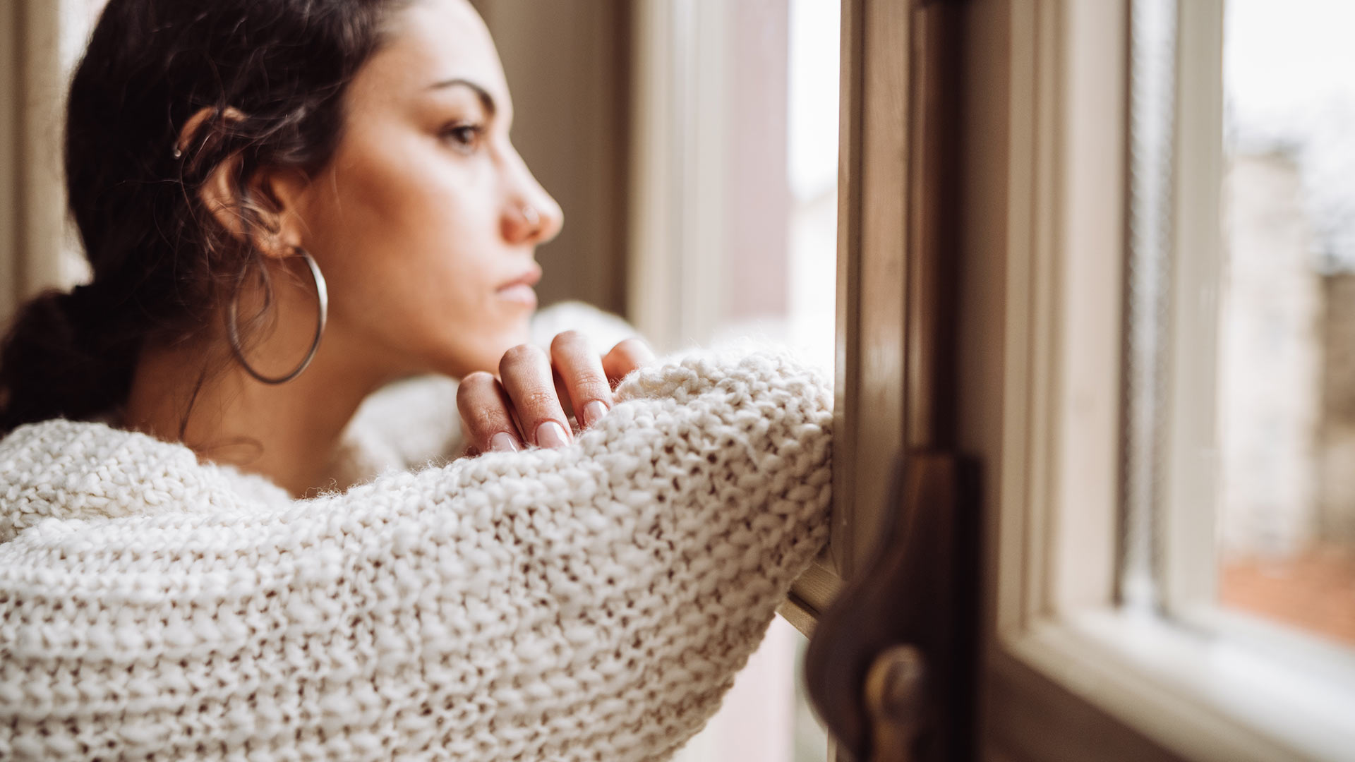 Femme regardant par la fenêtre